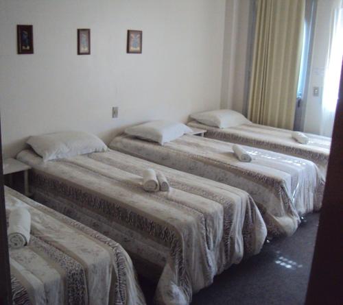 Giường trong phòng chung tại Pousada Dona Luiza