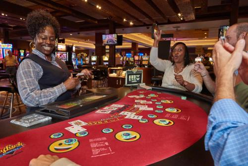 a group of people at a poker table in a casino at Bally's Vicksburg in Vicksburg