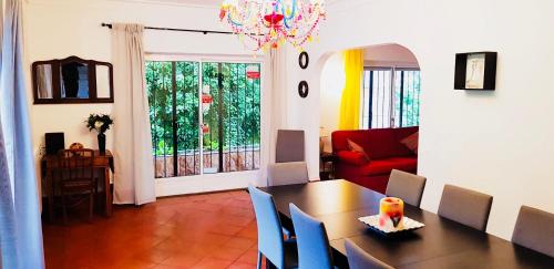 a dining room with a table and chairs and a living room at Cascais Dream Stay Guest House in Cascais