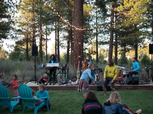 a group of people playing music in the grass at LOGE Bend in Bend