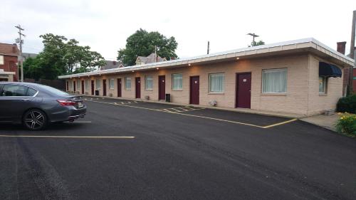 a car parked in a parking lot next to a building at Heritage Inn in Uniontown
