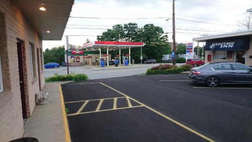 a car parked in a parking lot next to a gas station at Heritage Inn in Uniontown