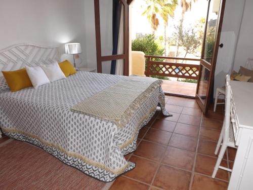 a bedroom with a bed and a balcony at La Manga Club Los Altos 1 in Atamaría