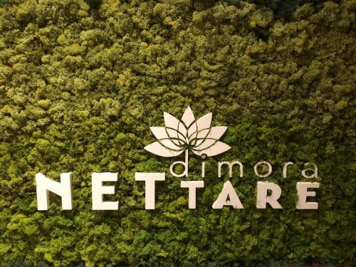 a sign with a lotus on top of a plant at Dimora Nettare in Brindisi