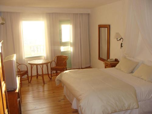 a hotel room with a bed and a table and chairs at Club Hotel Casapueblo in Punta del Este