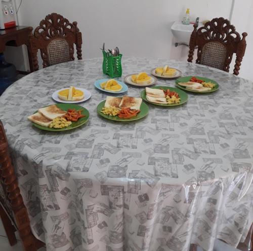 a table with plates of food on it at Arriani Homestay in Karimunjawa
