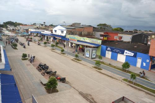 a street in a town with motorcycles parked on the street at Hotel Bahía Cadi in Puerto López