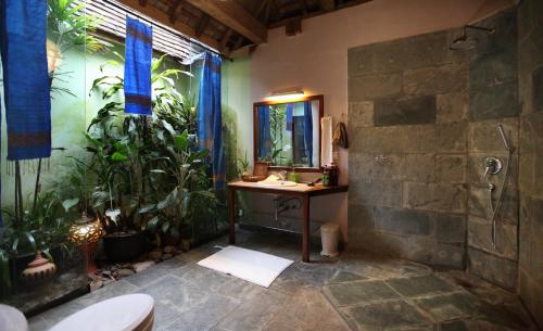 a bathroom with a sink and a shower with plants at You Ran Tai in Jinghong