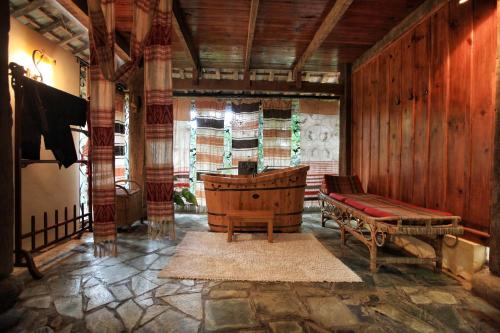 a living room with a bench and a wooden wall at You Ran Tai in Jinghong