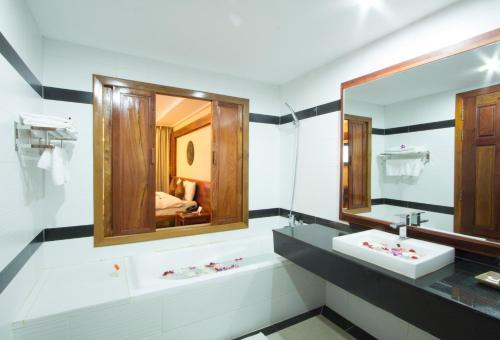 a bathroom with a sink and a mirror at Royal Empire Hotel in Siem Reap