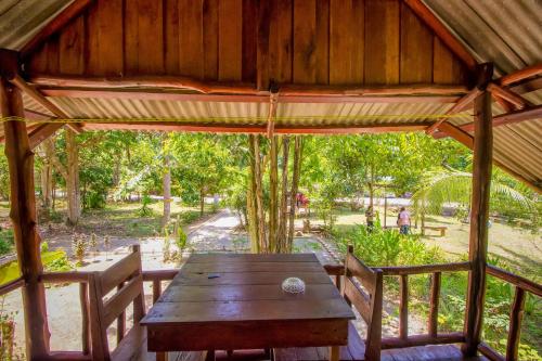 a wooden table in a pavilion with two chairs at Khao Sok Palmview Resort in Khao Sok