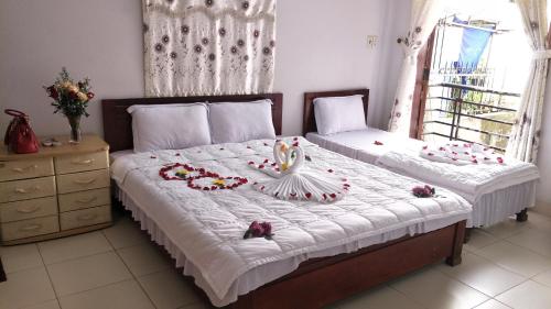 Thanh Huong Homestay tesisinde bir odada yatak veya yataklar
