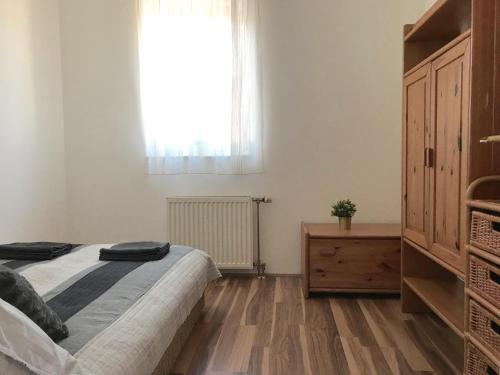a bedroom with a large bed and a window at Optimum Home in Pécs