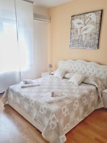 a bedroom with a large white bed with two dishes on it at Villa Grazia in La Spezia