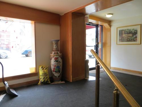 a hallway with a vase sitting next to a window at Chinatown Hotel Chicago in Chicago