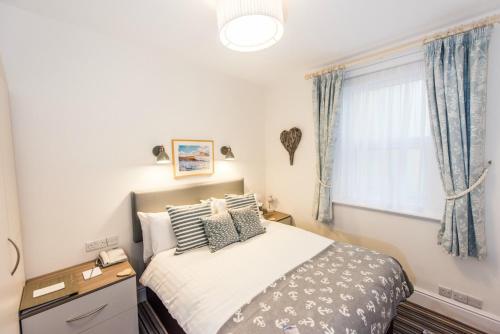 a bedroom with a bed and a window at The Kingswood Hotel in Sidmouth