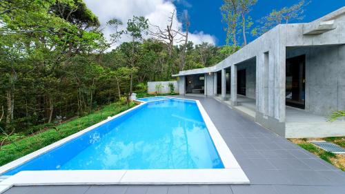 a swimming pool in the backyard of a house at Magachabaru Okinawa in Nakijin