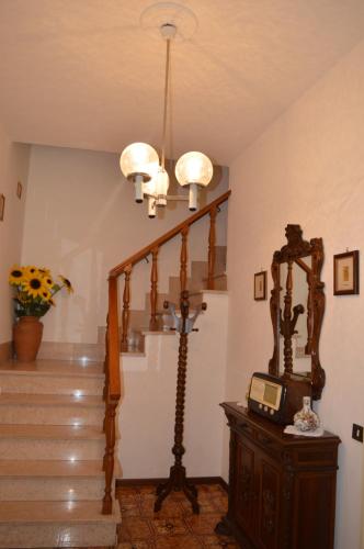 a room with a staircase with a clock on a table at La Piazzetta in Bolsena