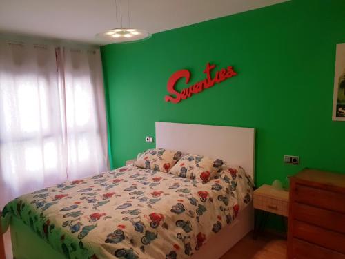 ポンテベドラにあるAPARTAMENTO HERREROS 28の緑の壁のベッドルーム(ベッド付)