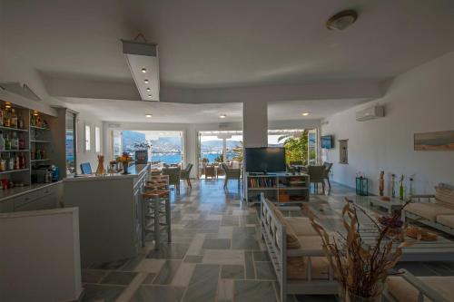 a kitchen and living room with a view of the ocean at Akrotiri Hotel in Parikia