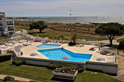 - une vue sur la piscine située à côté de la plage dans l'établissement Residence Ulysse Port Camargue, au Grau-du-Roi