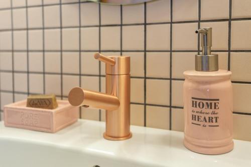 a bottle of soap and a soap dispenser on a sink at Casas da Formosa - Downtown Alegria in Tavira