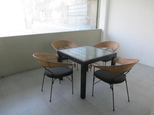 a table and chairs in a room with a window at Ripple Reach Apartments in Galle