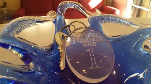 a pair of scissors sitting on top of a blue motorcycle at Hotel Firenze 2000 in Florence