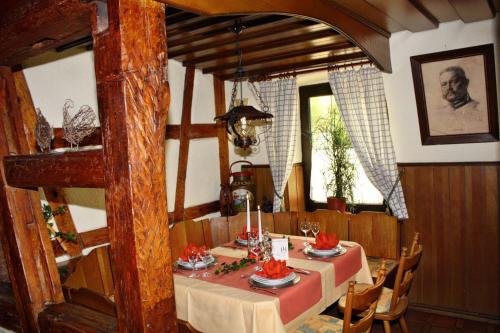 a dining room with a table in a house at Akzent Hotel Goldener Ochsen in Cröffelbach