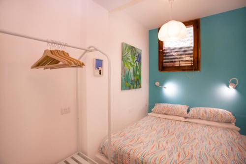 a bedroom with a bed in the corner of a room at Casa dell'Isola Bella Taormina mare in Taormina