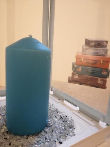 a blue vase sitting on a table in front of a mirror at Romantico Rifugio in Guardiagrele
