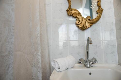 a bathroom with a sink with a roll of toilet paper at Eirinaki House in Patmos