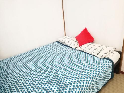 a bed with two pillows on top of it at 20 House Arugam in Arugam Bay