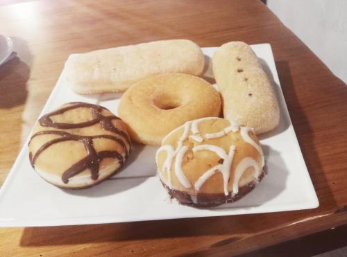 a plate of donuts and bread on a table at Hotel Montearoma in Valverde del Camino