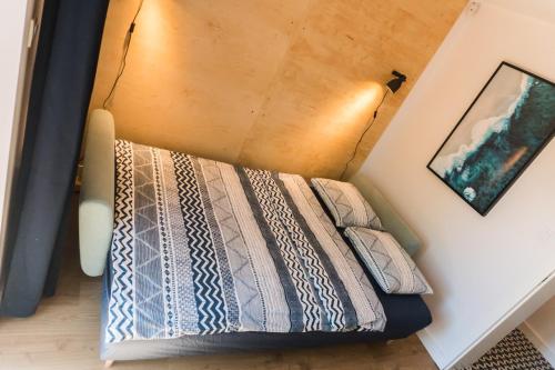 a bedroom with a bed with two pillows on it at Redlowskie Klify Apartments in Gdynia