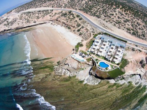 an aerial view of a resort next to the beach at Appart-hotel La Source in Taghazout