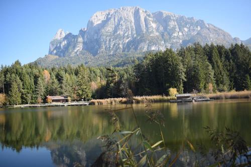 a large lake with a mountain in the background at Schlossblick in Vols am Schlern
