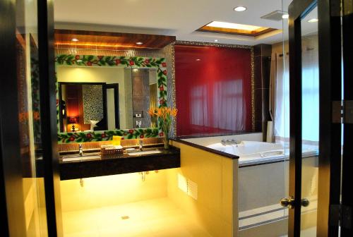a bathroom with a sink and a large mirror at Hotel Elizabeth Cebu in Cebu City