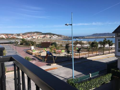 a balcony with a view of a playground at Hotel Playa de Laxe in Laxe