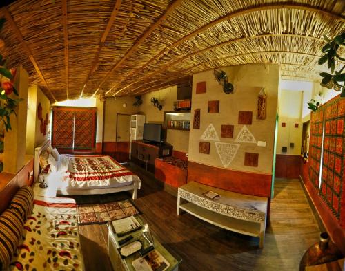 a large room with a bed and a couch at Tathastu Pench in Khawāsa