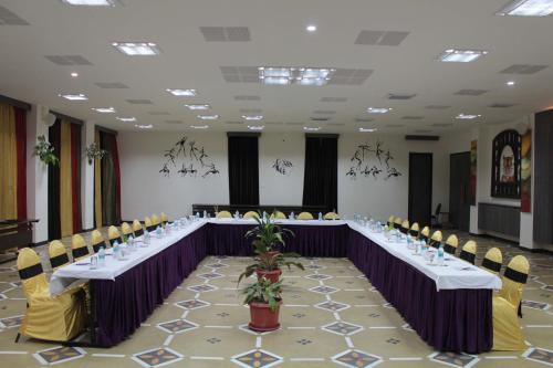 a conference room with a long table with chairs at Tathastu Pench in Khawāsa