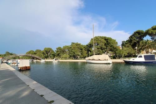 a group of boats are docked in a river at Narancin Apartments in Trogir