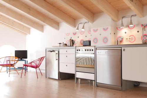 a kitchen with a stove and a bed in a room at Gut Pohnstorf in Alt Sührkow