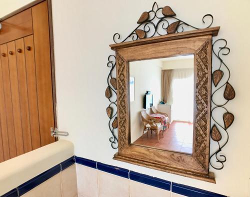 a mirror on a wall in a room with a chair at SpoonDrift Hostal Kenting in Nanwan