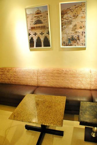 a living room with a couch and a coffee table at Hotel Elizabeth Cebu in Cebu City
