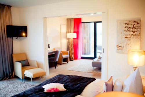 a room with a couch and a living room at Hotel Gut Bardenhagen in Bardenhagen