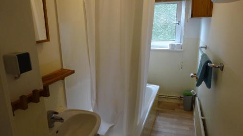 a bathroom with a sink and a bath tub at Private Room with Breakfast in Hannover