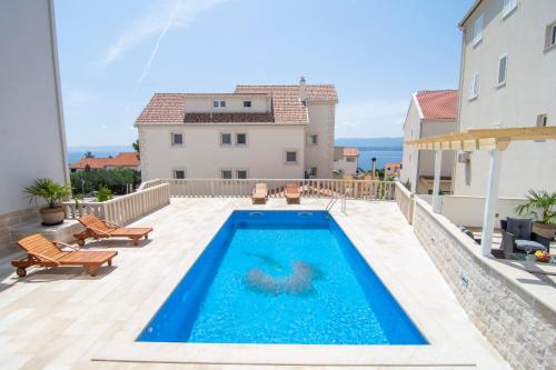 a swimming pool on the patio of a house at Apartments Sara 4 in Bol