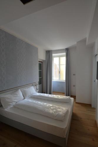 a bedroom with two beds and a window at Torrione Trento in Trento