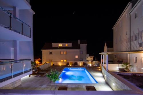 a swimming pool in the middle of a building at night at Apartments Sara 3 in Bol